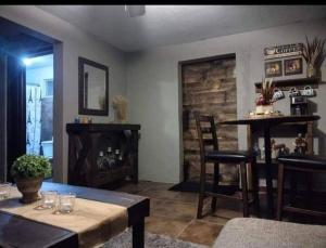 a living room with a table and chairs and a fireplace at Jardin Imperial in Mexicali