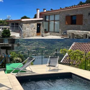 a house with a swimming pool and two lawn chairs at Casa da Lage - Gerês in Geres