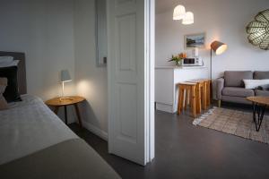 a bedroom with a bed and a living room at Casa Da Praia in Porto Formoso