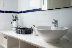 a bathroom with a white sink on a counter at Casa Da Praia in Porto Formoso