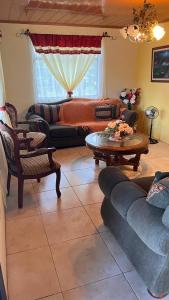 a living room with a couch and a table at Casa morfo in Bijagua