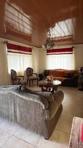 a living room with two couches and a table at Casa morfo in Bijagua