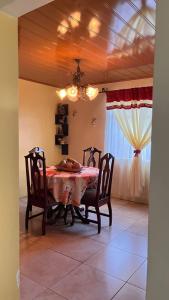 a dining room with a table and chairs and a window at Casa morfo in Bijagua