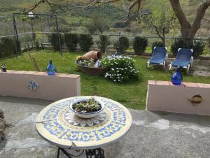 a table with a bowl on top of it in a yard at CASA VACANZE FONDACO DI SCILLATO in Scillato