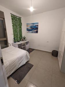 a bedroom with a bed and a green curtain at Private room in shared Apartment in Jerusalem