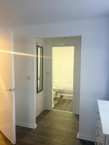an empty bathroom with a toilet and a sink at Comfortable and Cosy London Stay in London