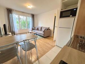 a kitchen and living room with a table and a couch at Entire appartment, 2 rooms confortable at Créteil in Créteil