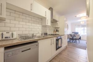 a kitchen with a sink and a counter top at Stylish Apartment 5 min Walk to Castle in Windsor