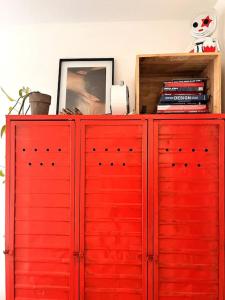 czerwona szafka z czerwonymi drzwiami w pokoju w obiekcie Lovely, light and calm 1-bedroom apartment w Amsterdamie