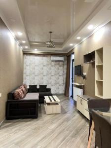 a living room with a couch and a table at vekuas apartments in Tbilisi City
