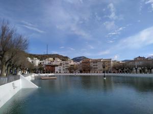 a large body of water in a city with buildings at CASA CUEVA EL OLIVO in Pegalajar