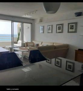 un salon avec un canapé et une table dans l'établissement Apartamento con acceso directo al mar en Altea y parking, à Altea