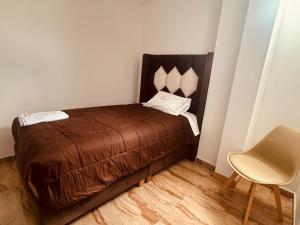 a small bedroom with a bed and a chair at HOTEL ROYAL INCA INN in Cusco