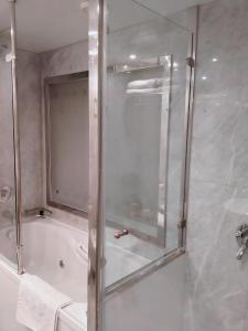 a shower with a glass door in a bathroom at Nile cruise, Luxor, Aswan, Floating hotel Alhambra A F in Aḑ Ḑab‘īyah