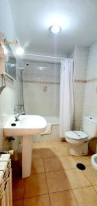 a bathroom with a white sink and a toilet at Sidreria La Casa Abajo in La Franca