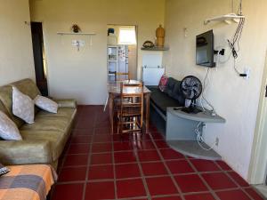 a living room with a couch and a table at Apartamento Aluguel Morro Branco. in Beberibe