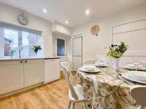 a kitchen and dining room with a table and chairs at Middle Farm Cottage in Avebury