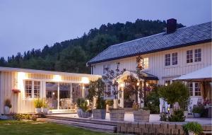 a large white house with a courtyard in front of it at Beautiful Home In Kolvereid With Kitchen in Kolvereid