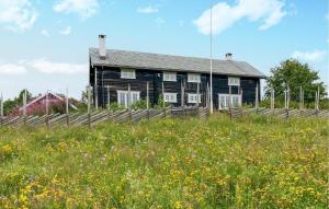 a house on a hill with a field of flowers at Stunning Home In Svatsum With House A Panoramic View in Svingvoll