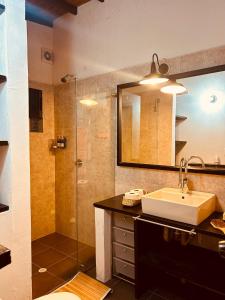 a bathroom with a sink and a shower with a mirror at Renacer Santa Elena in Medellín