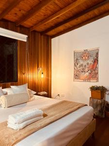 a bedroom with a large bed with wooden walls at Renacer Santa Elena in Medellín