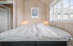 a white bed in a room with a window at Gorgeous Home In Fårevejle With Kitchen in Fårevejle +3 photos