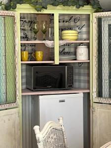 a cabinet with a microwave in a kitchen at Its Day One I Do Bridal Dressing Suite in Nassau