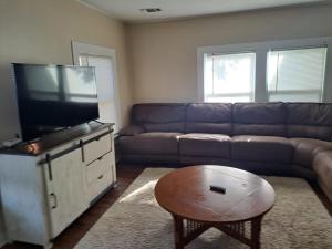 a living room with a couch and a flat screen tv at Near Trade Days and the Square and Pets welcome in Weatherford