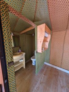 a bathroom with a sink and a toilet in a room at Merzouga Dunes Luxury Camps in Merzouga