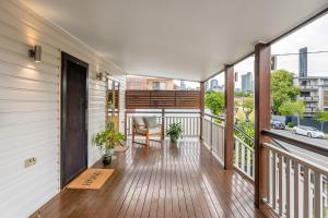 a balcony with a table and chairs on it at Beautiful Modern Home in Heart of New Farm in Brisbane