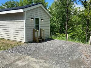 East OrangeCedar Creek! Privacy, quick walk to the beach的一座白色的小建筑,设有门廊和车道