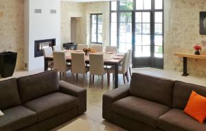 a living room with a table and a dining room at Le Mas D'edith in Maussane-les-Alpilles