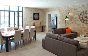 a living room with a table and a dining room at Le Mas D'edith in Maussane-les-Alpilles