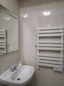 a white bathroom with a sink and a mirror at Quinta Souto da Ordem - House in Castelo Novo
