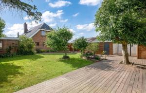 a garden with a wooden walkway in front of a house at Cozy Home In Lemvig With Kitchen in Lemvig