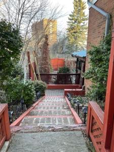 a garden with a stone walkway with two benches at Private, Spacious Apt Suite w/ Deck Free Parking in Mississauga