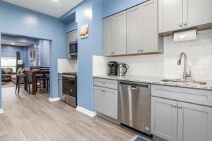 a kitchen with white cabinets and a dining room at Fabian's Place in Baltimore