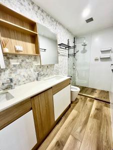 a bathroom with a sink and a toilet at Parkview Apartments in Brisbane