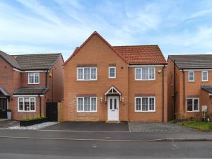 a row of brick houses with a white door at Buckthorn House in Middlesbrough