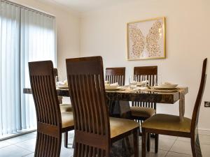a dining room with a wooden table and chairs at Buckthorn House in Middlesbrough