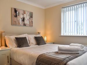 a bedroom with a large bed and a window at Buckthorn House in Middlesbrough