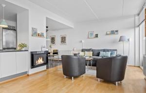 a living room with a couch and a fireplace at 3 Bedroom Stunning Apartment In Rm in Havneby