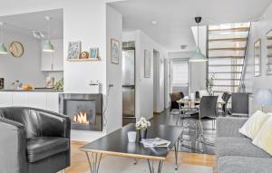 a living room with a couch and a fireplace at 3 Bedroom Stunning Apartment In Rømø in Havneby