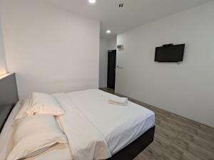Postel nebo postele na pokoji v ubytování Tambun Warm Hotel