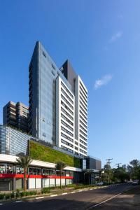 a tall building with a green wall on it at Vesta - melhor localização Torres in Torres