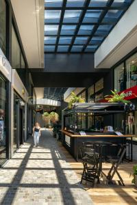 a person walking down a sidewalk in a building at Vesta - melhor localização Torres in Torres +3 photos