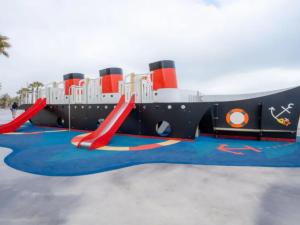 a playground with a slide and red slides at Appartement Moderne 5 Couchages avec Parking et Piscine - FR-1-748-8 in Canet-en-Roussillon