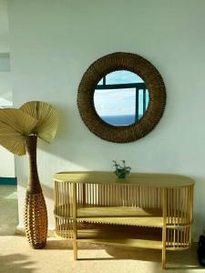 a room with a table and a mirror and a vase at Juan Dolio, Beach Access 2 BR Apt Salitre Tower front of Club Hemingway in Juan Dolio