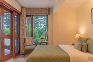 a bedroom with a bed and a window at Jais Cottage A Charming Hideaway in Shimla