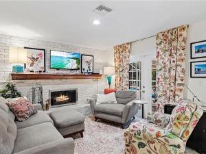 ein Wohnzimmer mit Couch und Kamin in der Unterkunft 7 Palms Pool House in Cape Coral